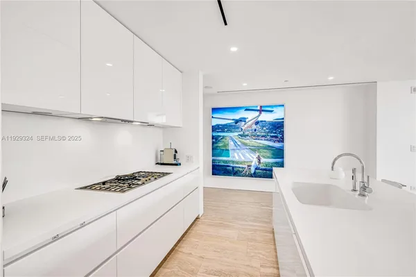 a kitchen with stainless steel appliances kitchen island a white stove top oven and sink