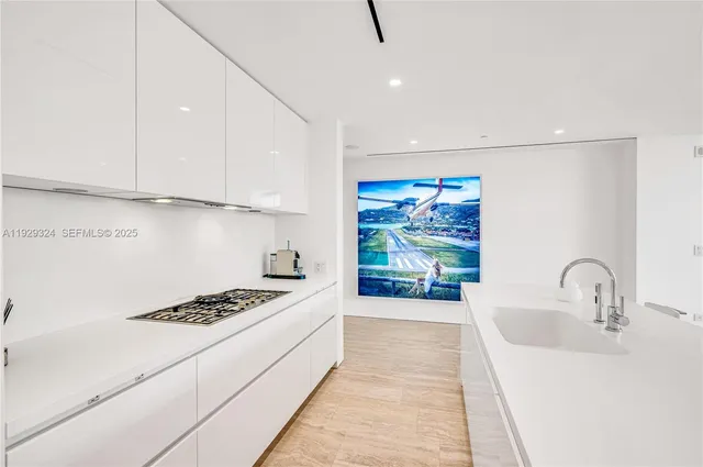 a kitchen with stainless steel appliances kitchen island a white stove top oven and sink