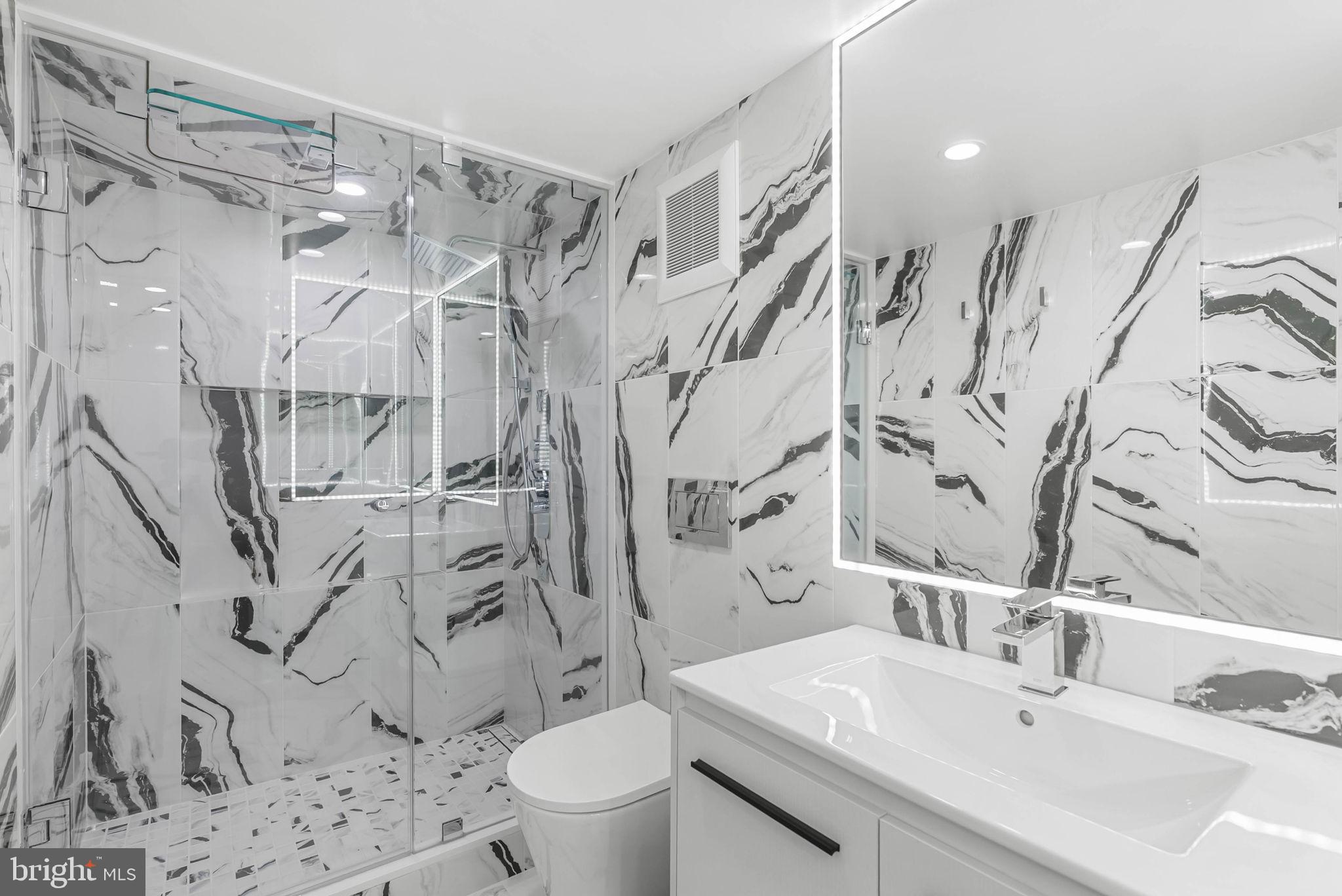219 South 18th Street, Unit 710 Philadelphia, PA 19103 - Photo 23 of 51 a bathroom with a sink toilet and shower