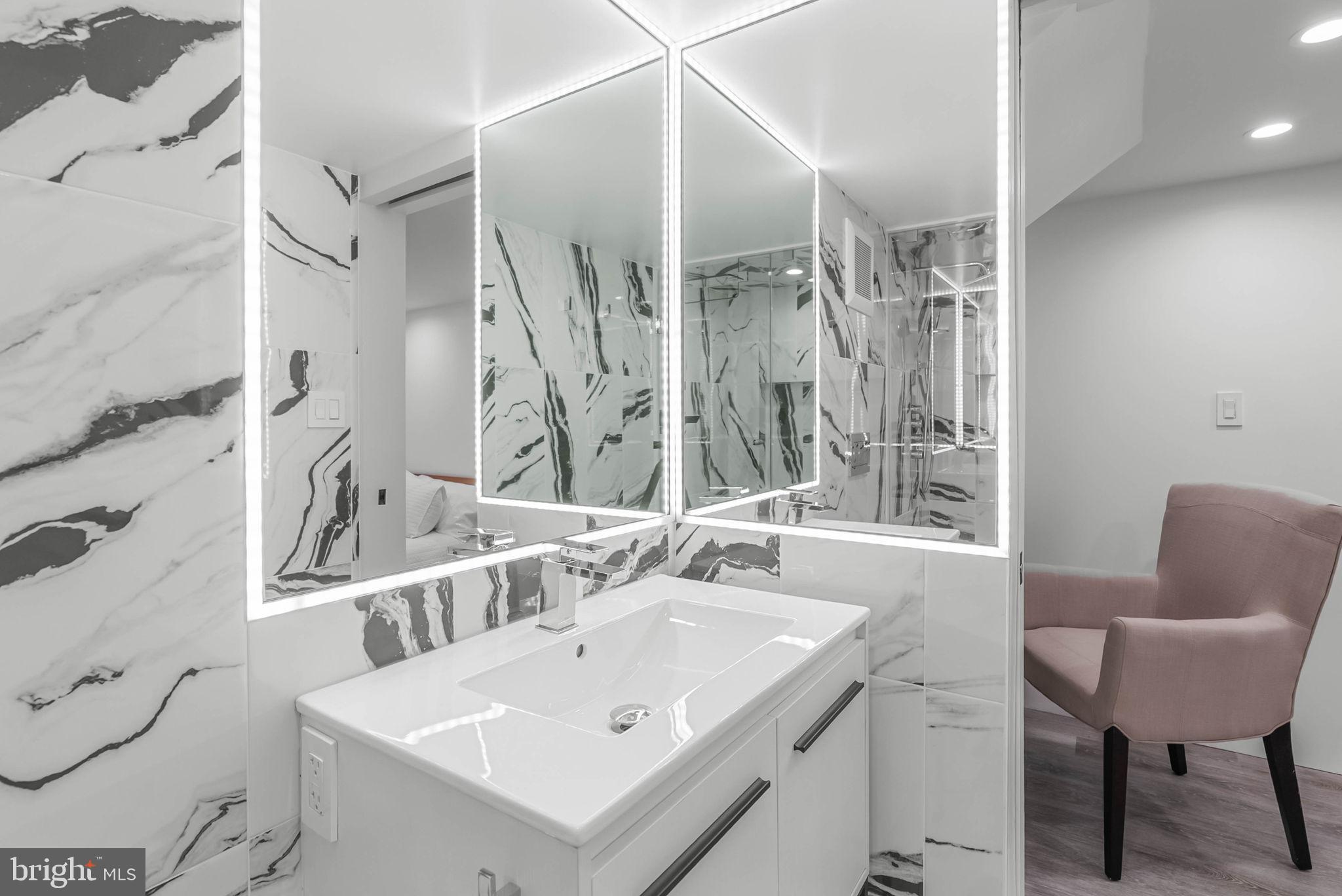 219 South 18th Street, Unit 710 Philadelphia, PA 19103 - Photo 24 of 51 a bathroom with a sink and a mirror