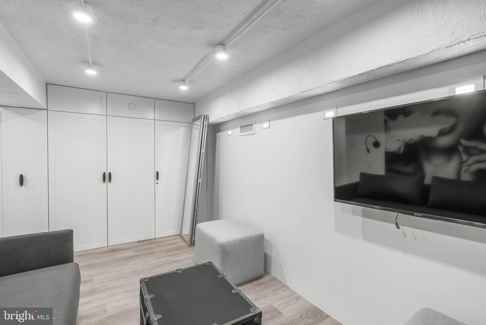 219 South 18th Street, Unit 710 Philadelphia, PA 19103 - Photo 31 of 51 a living room with furniture and a flat screen tv