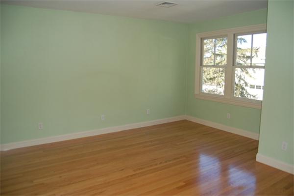 22 Martingale Road Lexington, MA 02421 - Photo 22 of 26 an empty room with wooden floor and windows