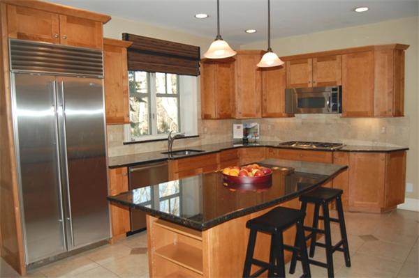 22 Martingale Road Lexington, MA 02421 - Photo 10 of 26 a kitchen with a table chairs sink and cabinets