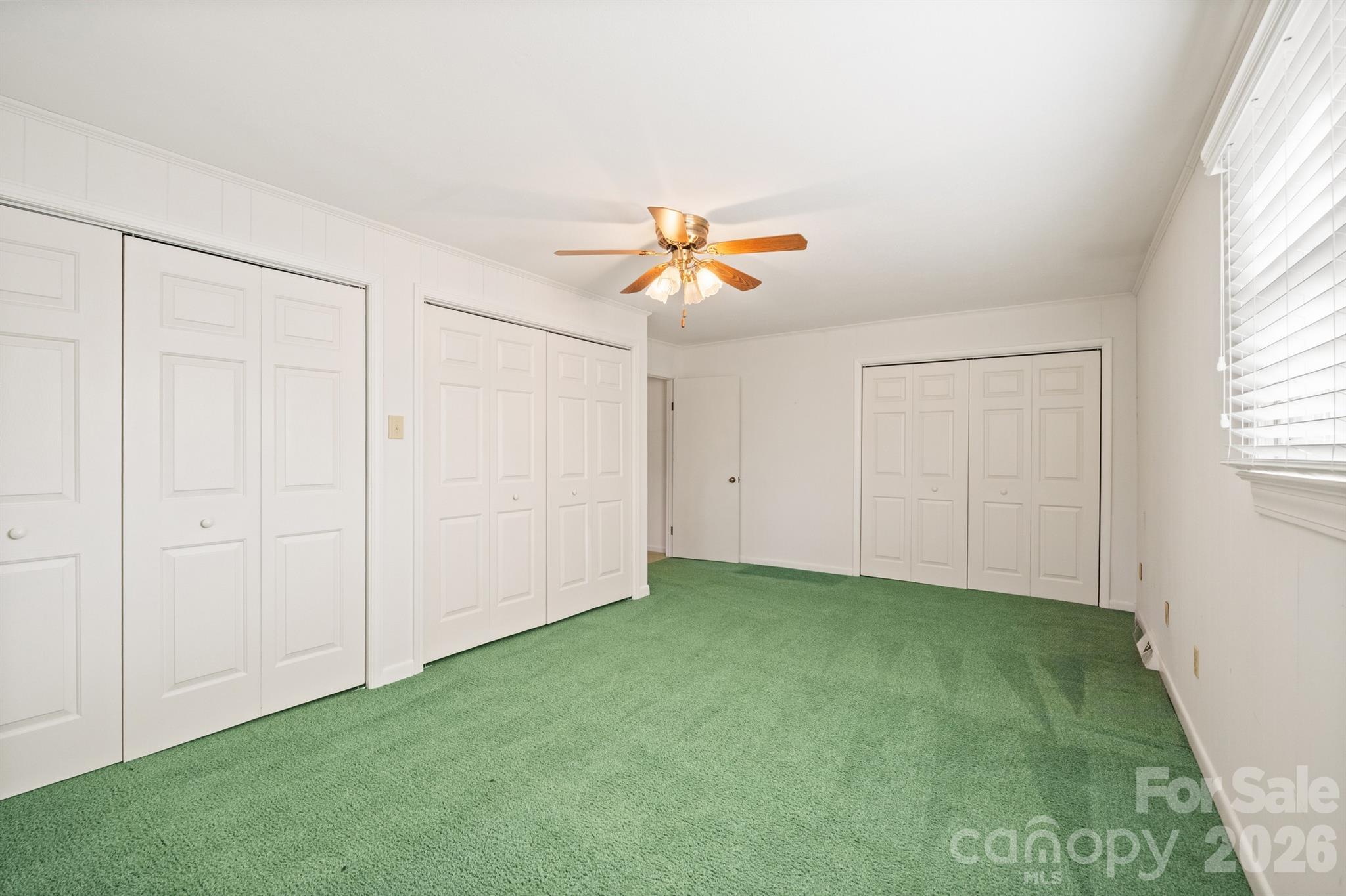 482 Miller Farm Road Statesville, NC 28625 - Photo 11 of 46 an empty room with closet and a ceiling fan