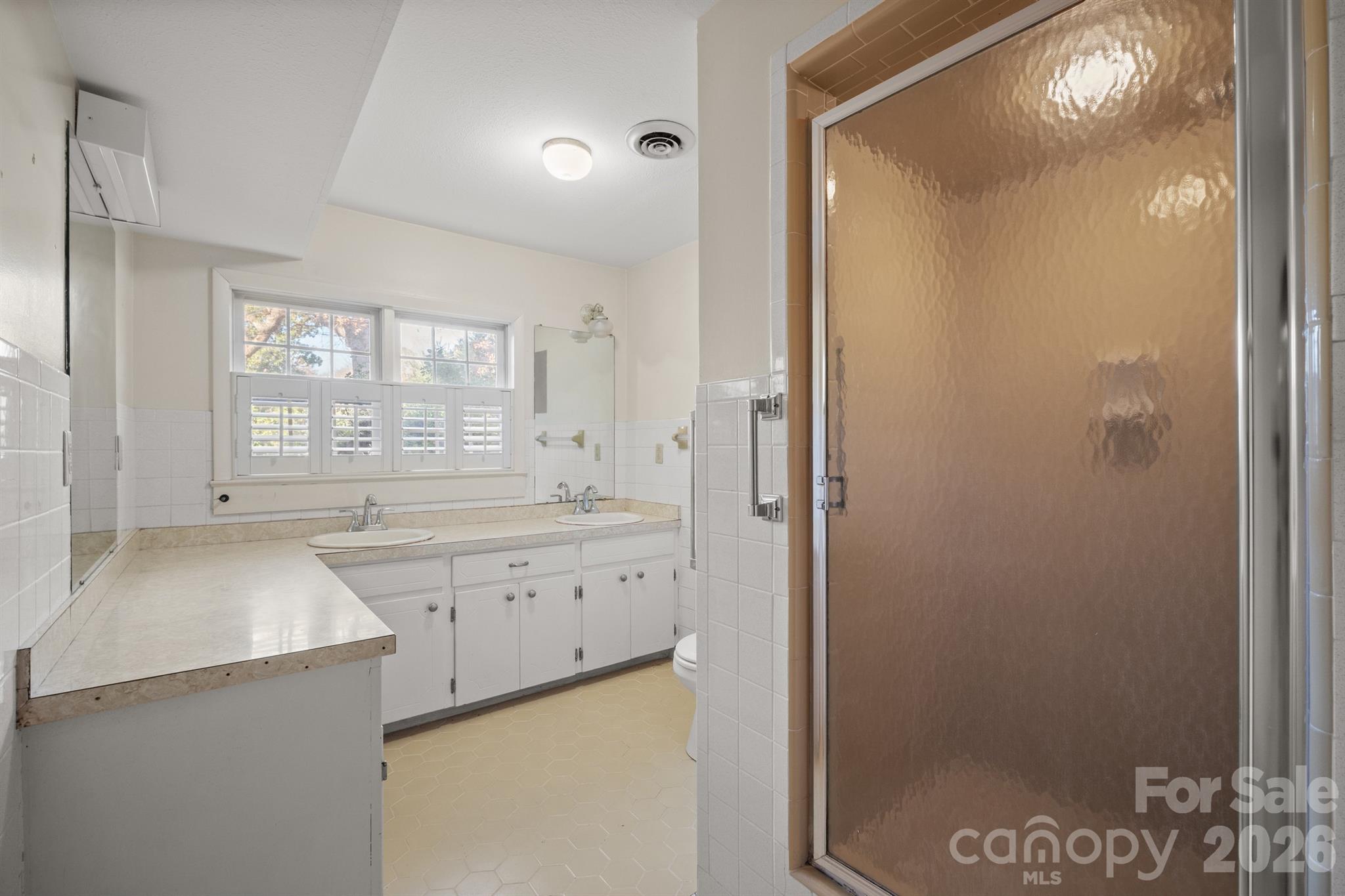 482 Miller Farm Road Statesville, NC 28625 - Photo 22 of 46 a spacious bathroom with a granite countertop sink a mirror and a shower