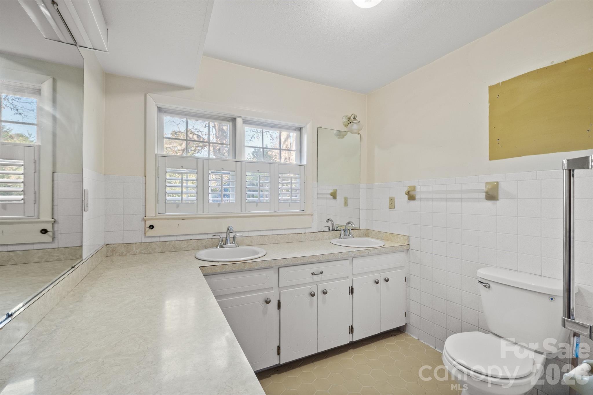482 Miller Farm Road Statesville, NC 28625 - Photo 23 of 46 a spacious bathroom with a granite countertop toilet sink and mirror