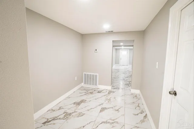 a view of a big room with cabinet and mirror