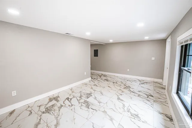 a view of a big room with wooden floor and bedroom