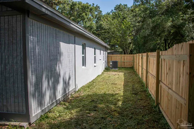 a view of a backyard with wooden fence