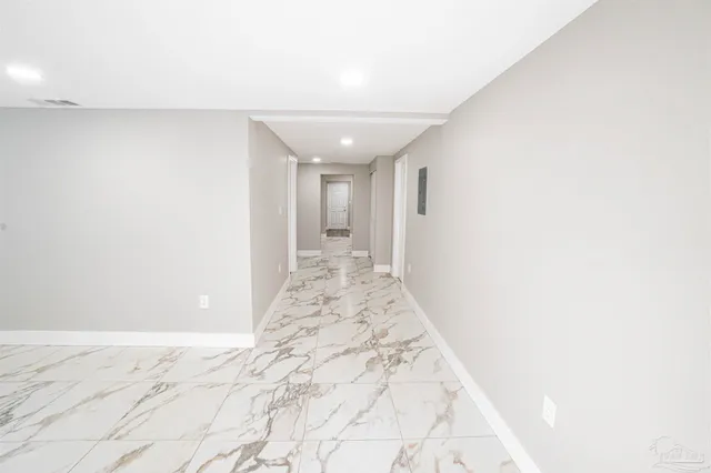 a view of a big room with wooden floor and cabinet