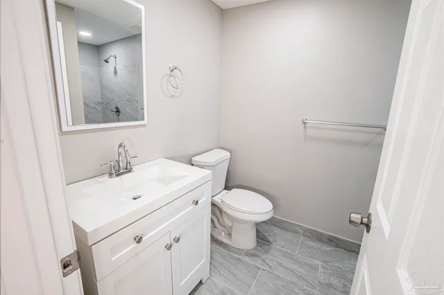a bathroom with a sink a toilet and mirror