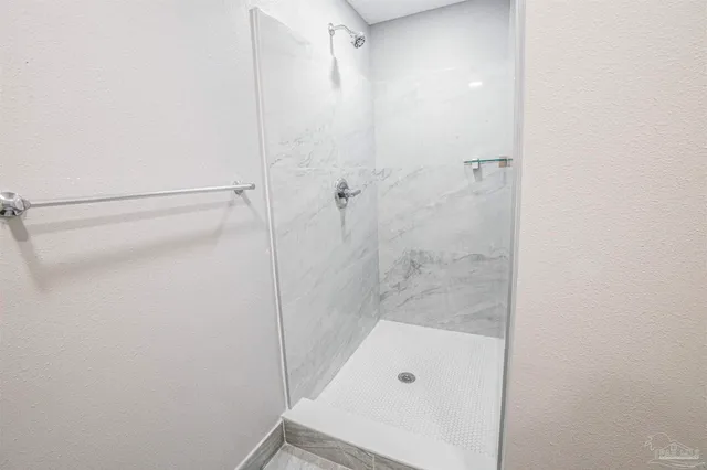 a bathroom with a tub and shower