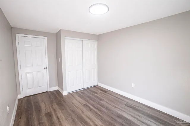 a view of an empty room and wooden floor