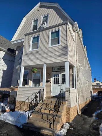 a front view of a house with large windows