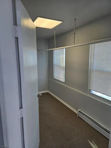 a view of an empty room with windows
