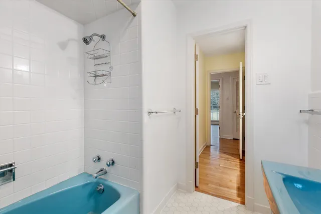 a bathroom with a tub a sink and shower