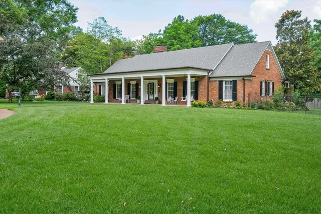 a front view of a house with a garden