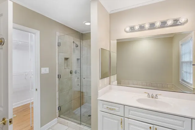 a bathroom with a shower sink and mirror