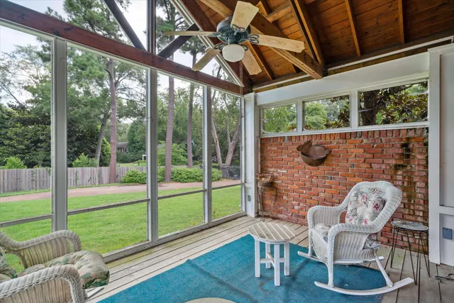 a view of a porch with furniture and a yard