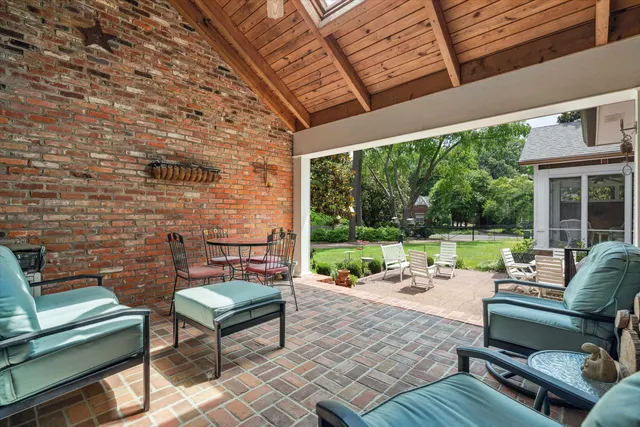 a view of a patio with a table and chairs