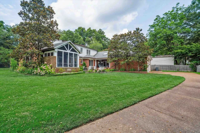 a front view of house with yard and green space