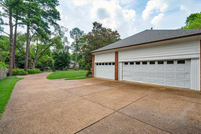 a view of a house with a yard and garage