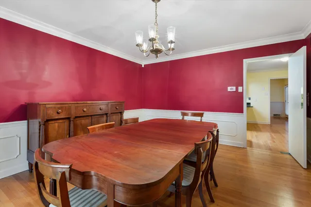 a dining room with a table and chairs