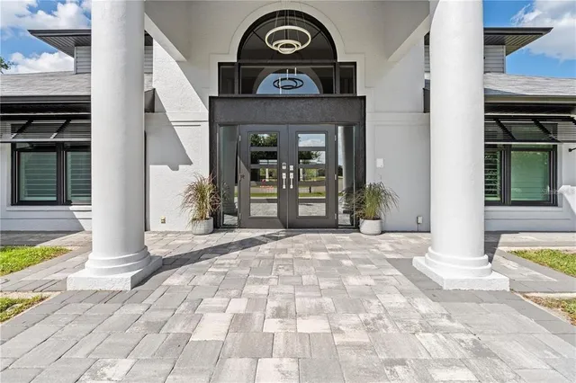 a living room with furniture gym equipment and a large window