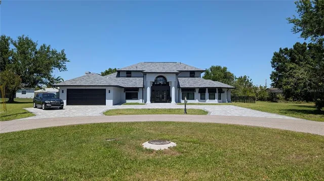 a kitchen with stainless steel appliances kitchen island granite countertop a table chairs and a refrigerator