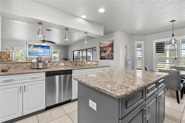 a kitchen with stainless steel appliances granite countertop a stove and cabinets