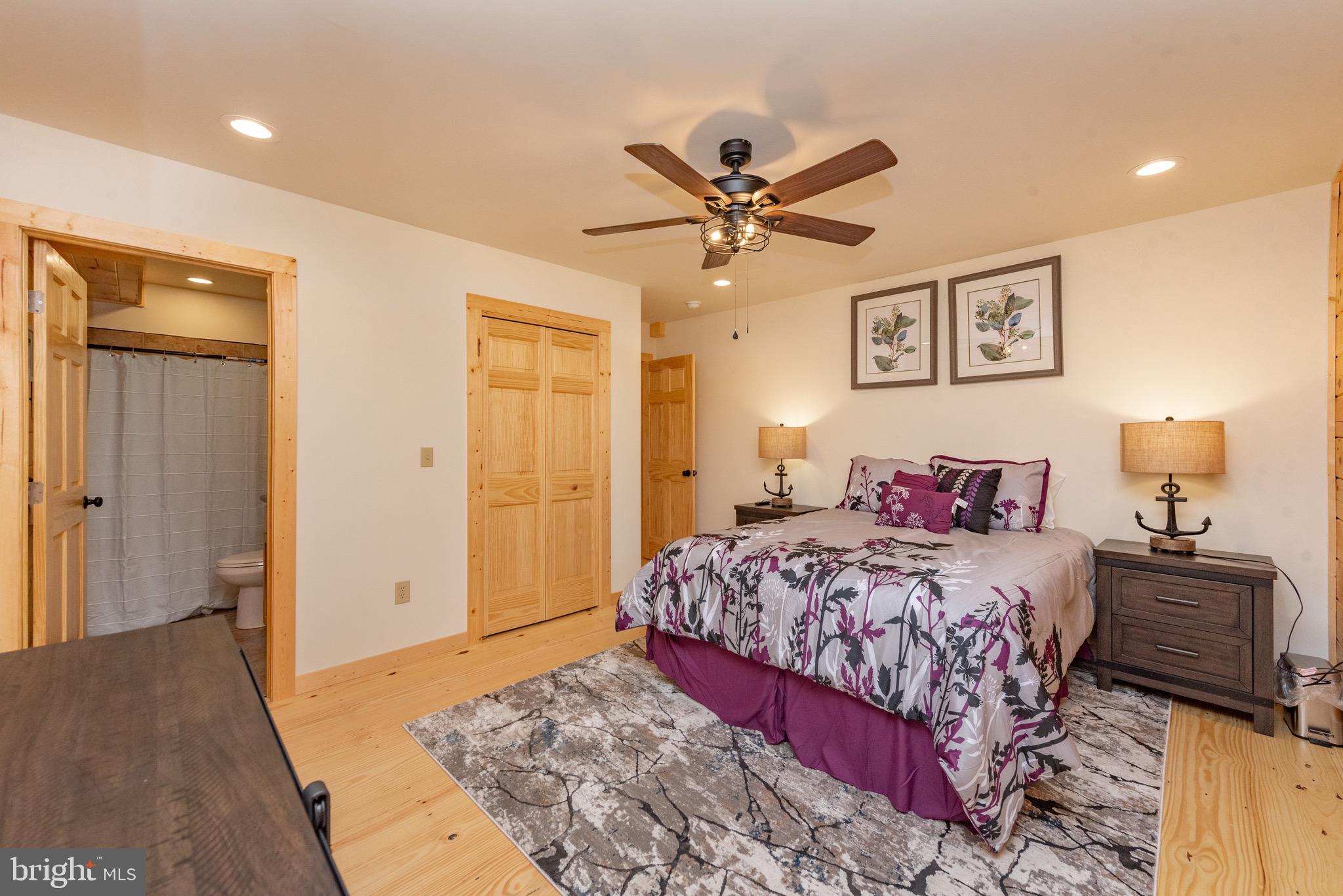 37 Ridgeline Trail McHenry, MD 21541 - Photo 21 of 59 a bedroom with a large bed and a chandelier