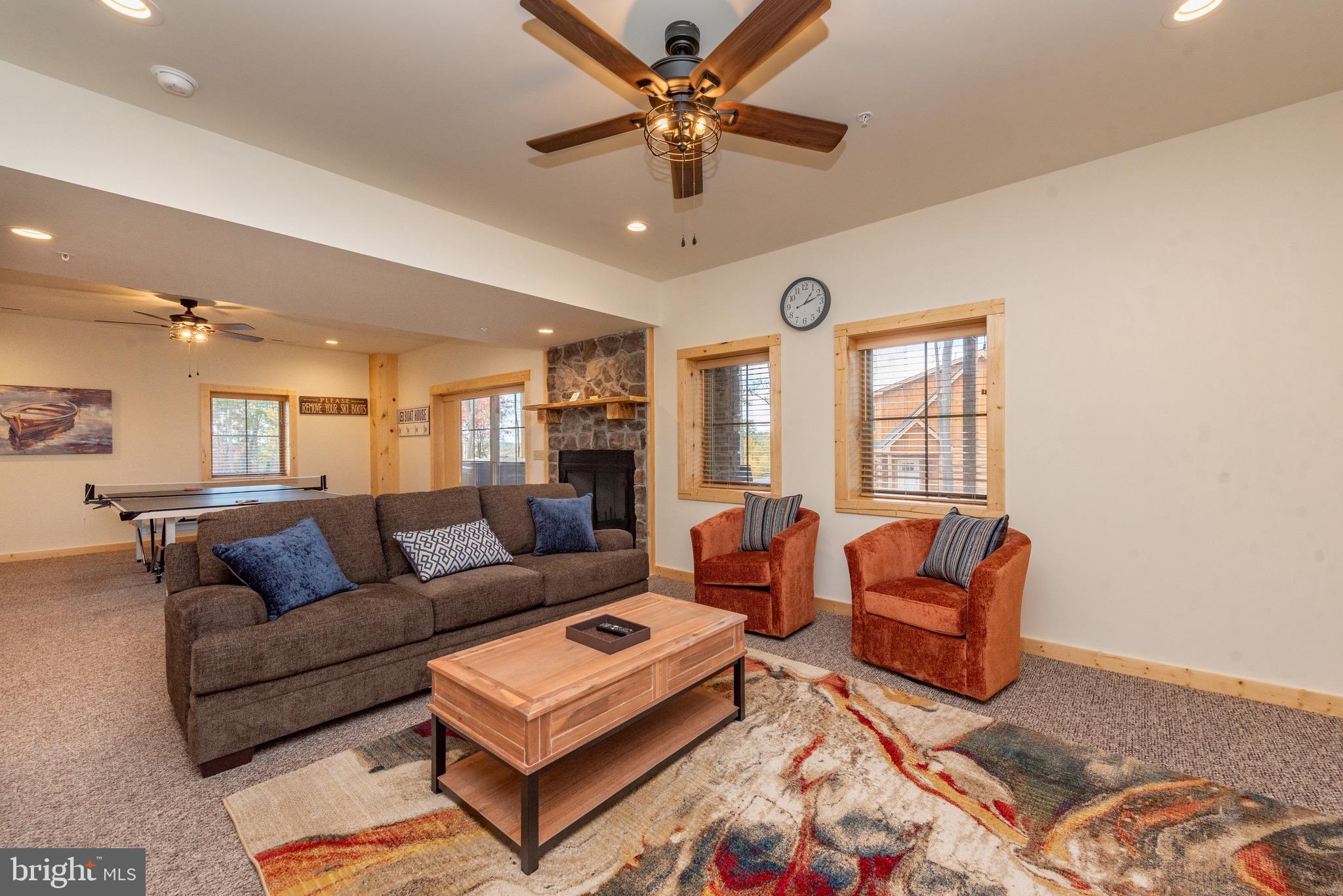 37 Ridgeline Trail McHenry, MD 21541 - Photo 42 of 59 a living room with furniture a ceiling fan and a rug