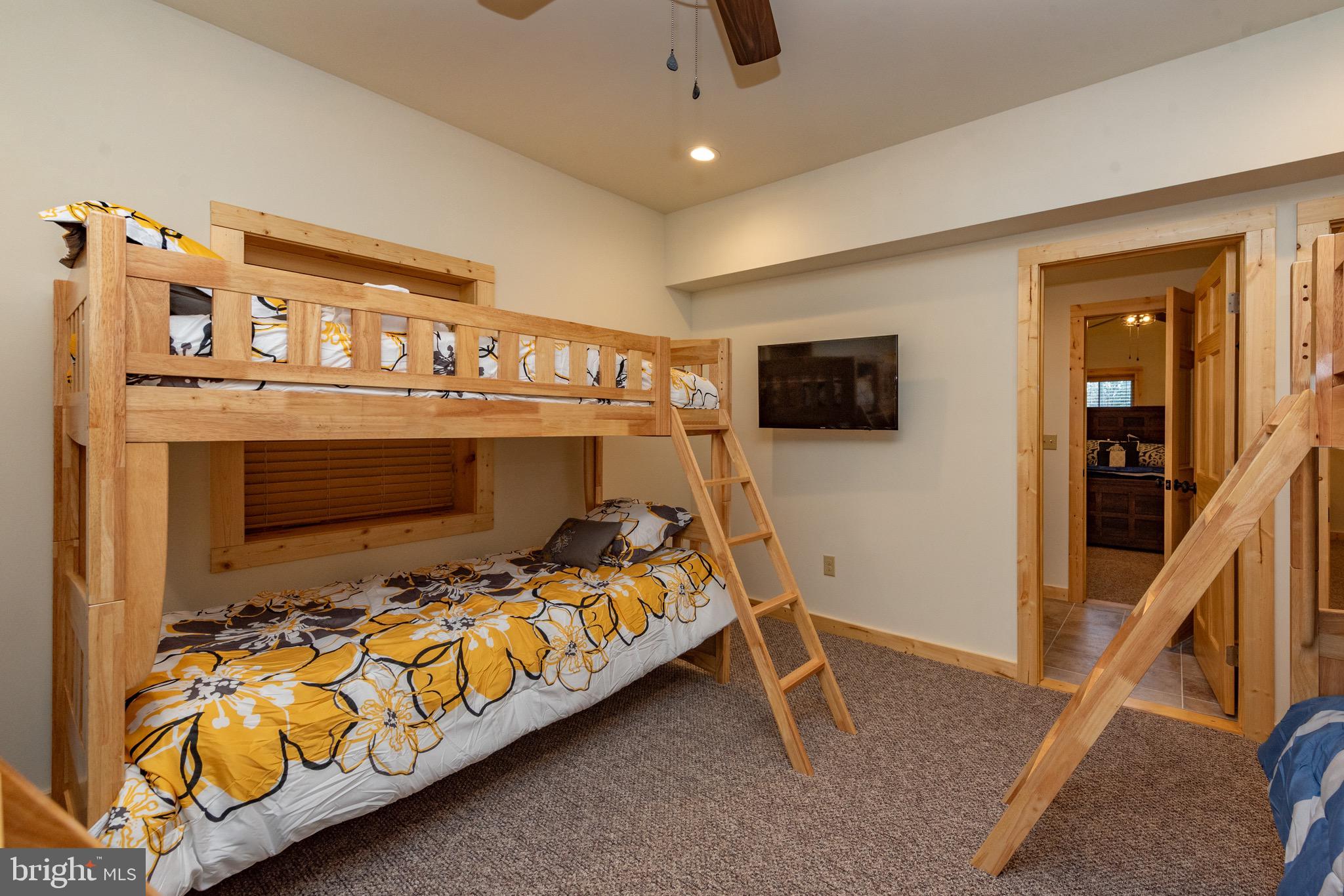 37 Ridgeline Trail McHenry, MD 21541 - Photo 49 of 59 a bedroom with a bed and a flat tv screen on the dresser