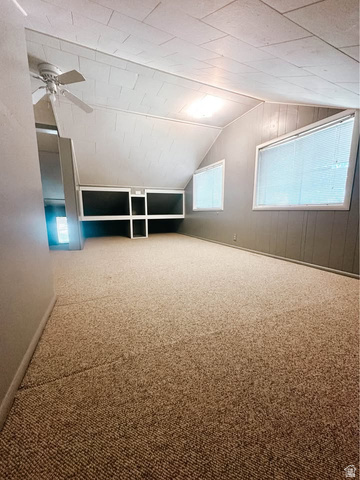 393 Old Mill Road Glenwood, UT 84730 - Photo 9 of 10 Spacious room featuring sloped ceilings, textured wall panels, and two windows with blinds