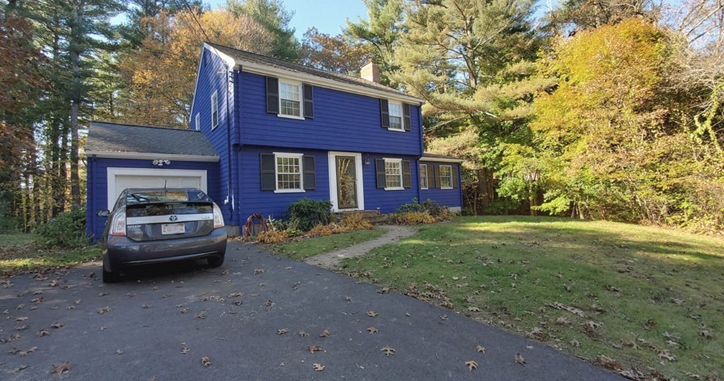 a car parked in front of a brick house