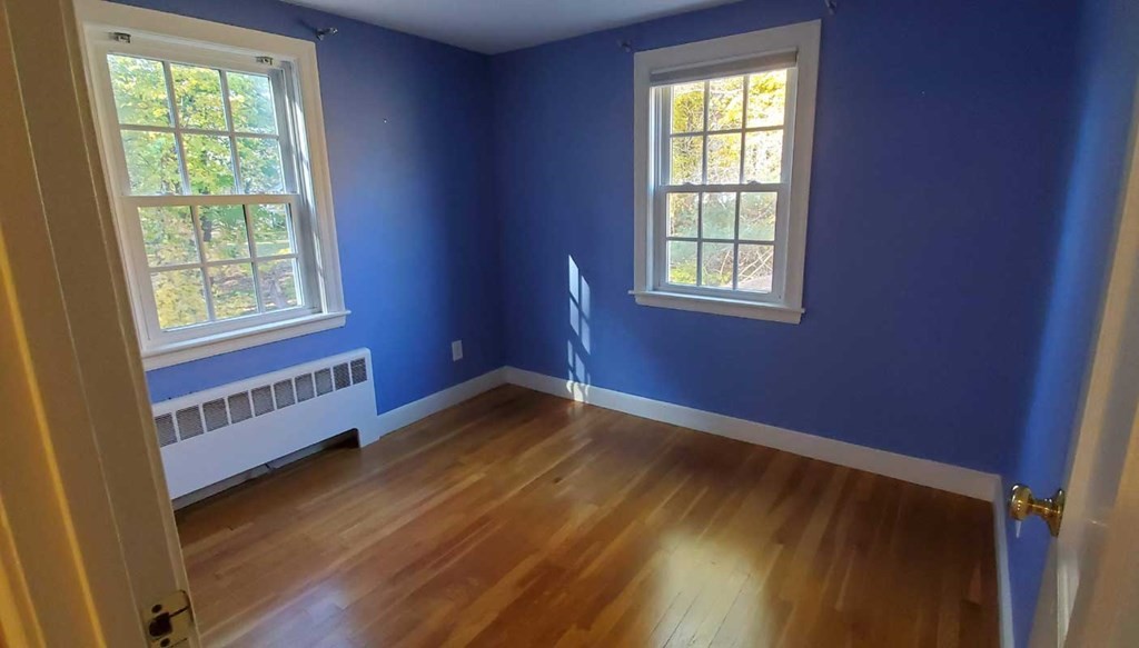 250 Concord Road Wayland, MA 01778 - Photo 13 of 16 a view of an empty room with wooden floor and a window