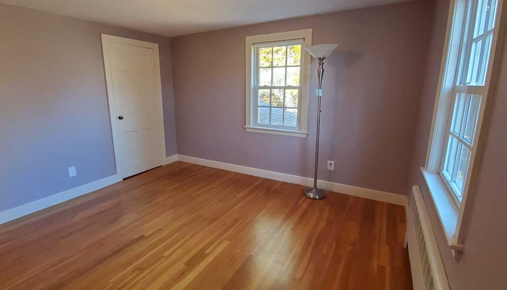 250 Concord Road Wayland, MA 01778 - Photo 14 of 16 an empty room with wooden floor and windows