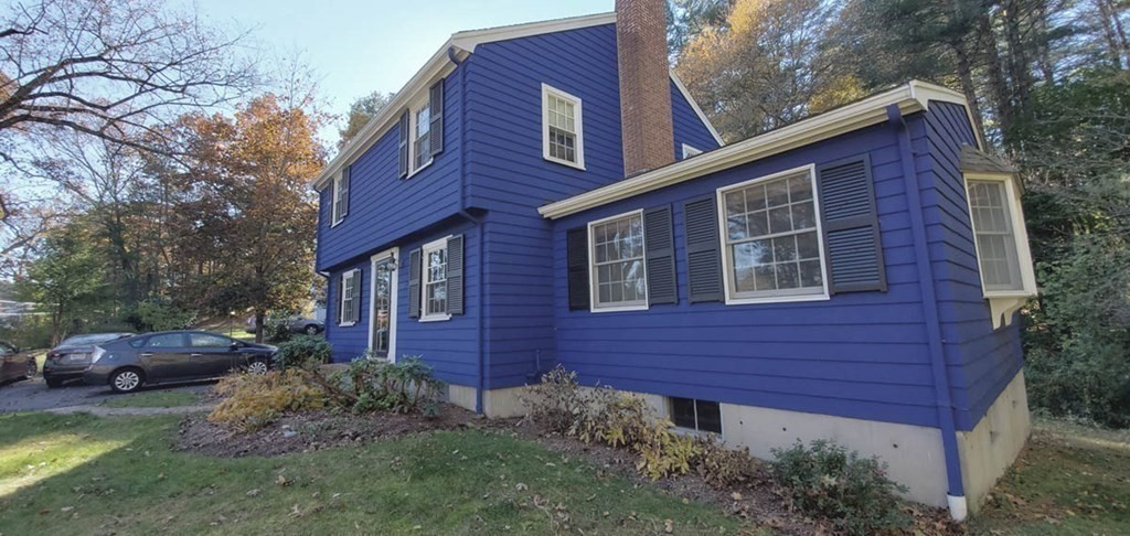 250 Concord Road Wayland, MA 01778 - Photo 3 of 16 a front view of a house with a garden