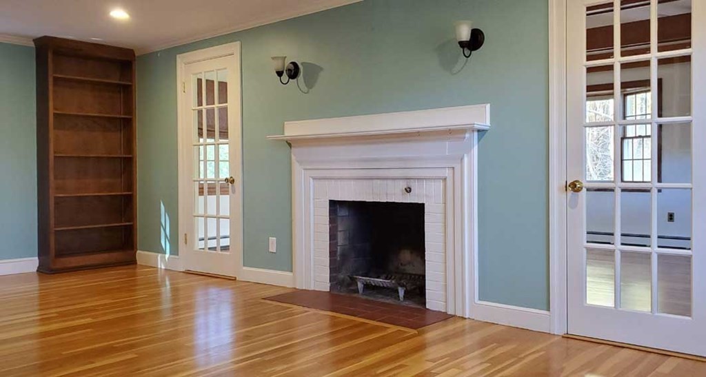 250 Concord Road Wayland, MA 01778 - Photo 4 of 16 a view of an empty room with wooden floor and a window