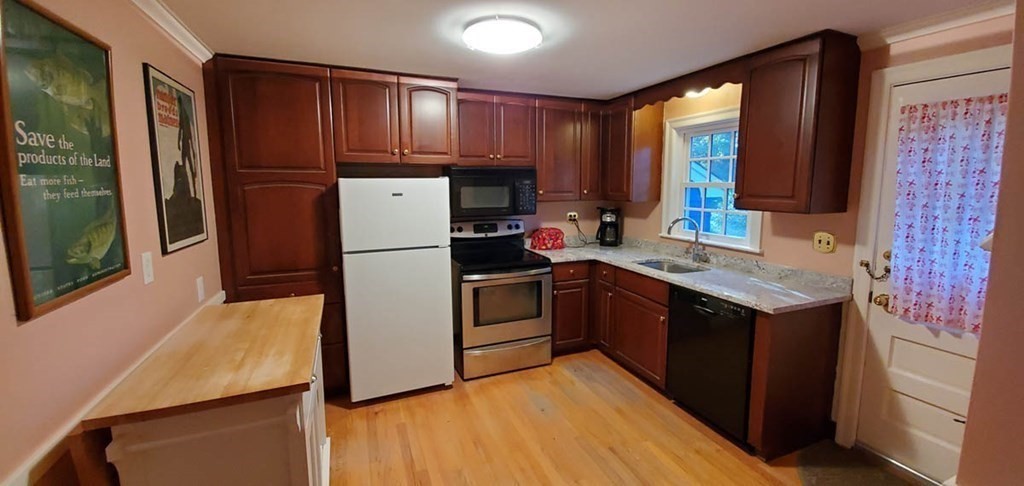 250 Concord Road Wayland, MA 01778 - Photo 10 of 16 a kitchen with a refrigerator sink and cabinets