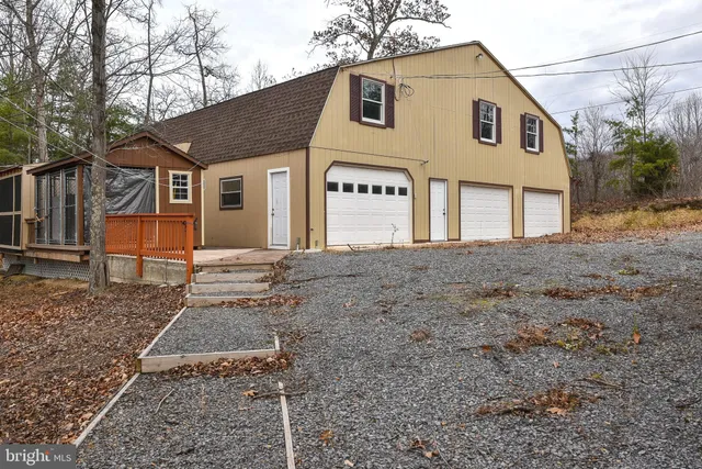 a backyard of a house with wooden floor and fence