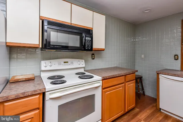 a view of a chairs and table in the back yard