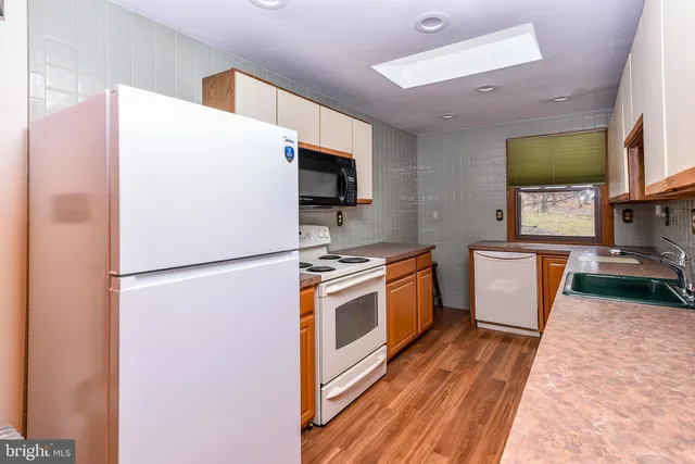 a view of a balcony with chairs and wooden fence