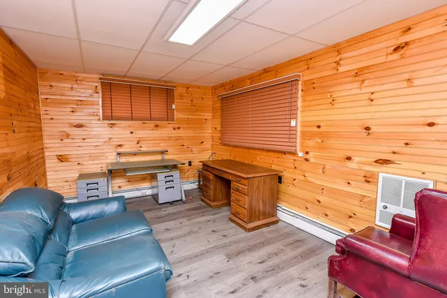 a view of a livingroom with wooden floor and furniture