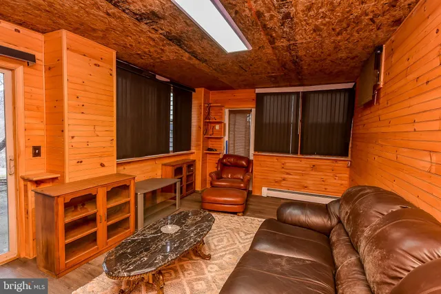 a living room with furniture gym equipment and a window