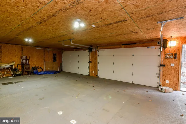 a living room with furniture gym equipment and a window