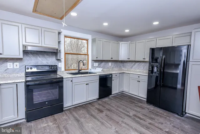a view of a house with a yard and sitting area