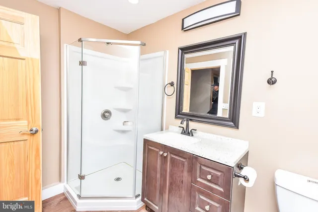 a view of a house with a yard and large tree