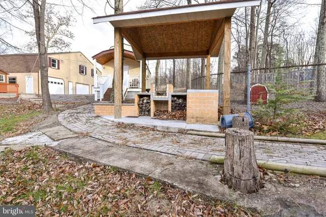 a dining room with furniture a chandelier and wooden floor
