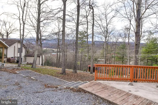 a living room with furniture a fireplace and wooden floor